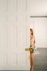 Bridal boudoir portrait with peach and cream bouquet by Flowergirl Cville at Virginia Creative Collective, Staunton VA | Photo by Lyn Waldrop Photography
