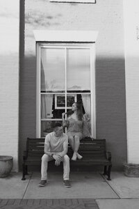couple sitting on bench during atlanta georgia engagement photos