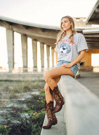 Senior portrait in Gulf Shores, Alabama — sitting on a rail