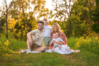 A family of four sits in a quiet area of Minooka Park in Waukesha while their photos are taken.