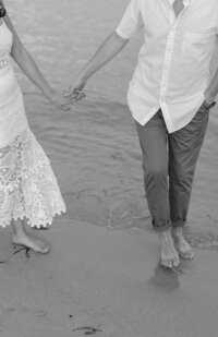 Close up images of couple holding hands on beach in Miami.