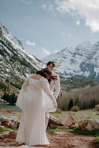 bride and groom in front of the maroon bells