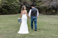 Bride and Groom walking together at Azle Deer Cove captured by Graceful Ray Photography in Fort Worth Texas