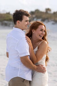 A candid engagement photo taken on Jacksonville beach before sunset. Photo credit: Phavy Photography, Engagement Photographer in St. Augustine FL