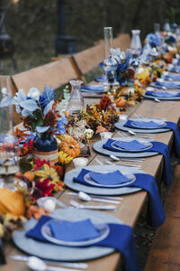 a blue table setting for a wedding