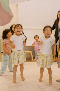 Twin toddlers jumping with excitement during their Silicon Valley toddler play group