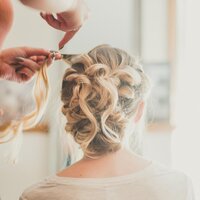 bride getting her hair styled
