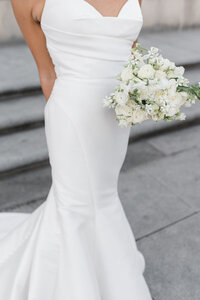 Bride holding floral arrangement at Cincinnati wedding, photographed by Courtney Rudicel