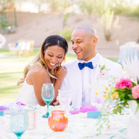 bride and groom portrait laughing at head table