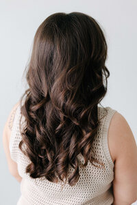 SoCo stylist creating voluminous curls using the Ft. Worth technique for long-lasting bounce