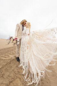 man and woman kissing at Sand Dunes Elopement Photographer Savvy Shoots Photography