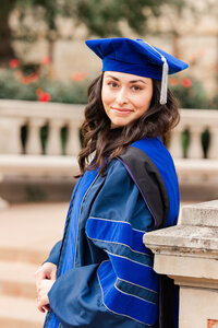 Colorado graduation portraits—PhD graduate in blue doctoral regalia smiling at the camera