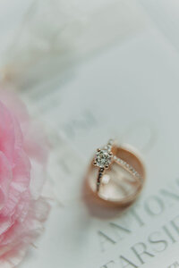 Close-up of the wedding rings, symbolizing eternal love, elegantly presented against a backdrop that reflects the couple's unique style.
