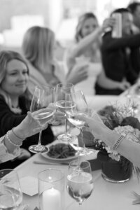 Guest clink glasses and cheers during wedding reception.