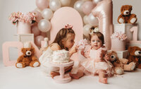 Charleston Cake Smash Photographer- Baby looks into the camera during Cake Smash Photos at Holy City Babies Portrait Studio in Charleston, SC.