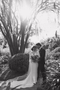 Bride and Groom on wedding day in flower garden in charleston south carolina