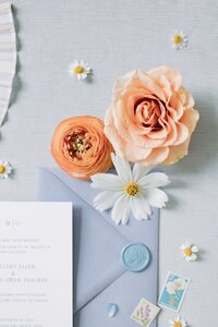 Wedding invitation flat lay with peach garden roses and daisies by Flowergirl Cville, Charlottesville florist, at King Family Vineyard | Photo by Paige Ryan Photography