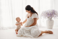 Charleston Motherhood Photographer - Mother poses with her baby during studio Mother's Day Mini Sessions at Holy City Babies Portrait Studio in Charleston, SC.