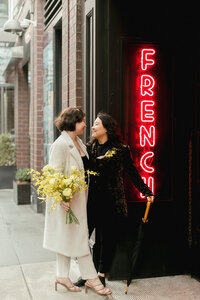 Couple poses together outside of the Ludlow Hotel in New York City