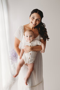 Charleston Motherhood Photographer - Mother poses with her baby during studio Mother's Day Mini Sessions at Holy City Babies Portrait Studio in Charleston, SC.