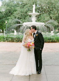 Bride and Groom Kissing in Front of Forsyth Fountain Photo