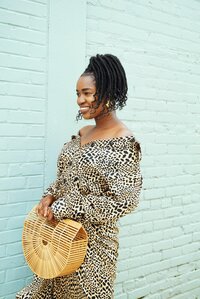 Confident woman wearing sunglasses and a chic outfit, representing solo travel and style.