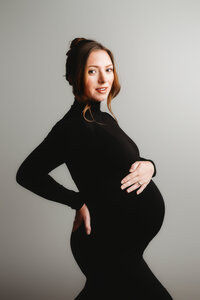 Pregnant mother poses for Fine Art, Editorial Style Studio Maternity Portraits in Charleston, SC.