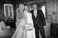 Bride is hugged by parents during wedding on Nantucket.