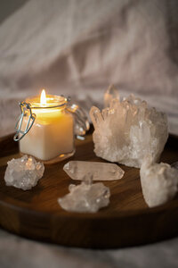 White healing crystals and candle used for spiritual energy cleansing
