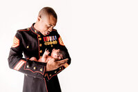 Newborn baby held by parent in military uniform in New Bern North Carolina
