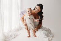 Charleston Motherhood Photographer - Mother poses with her baby during studio Mother's Day Mini Sessions at Holy City Babies Portrait Studio in Charleston, SC.