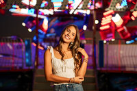 Senior portrait at the Greater Gulf State Fair in Mobile, Alabama — playing with her hair in front
of a twirling ride.