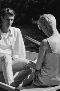 man and woman looking at each other while sitting in a boat