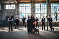A band standing together in an empty building