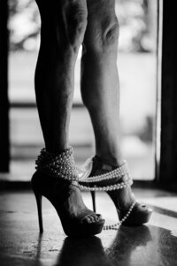 Boudoir experience studio pearls around her ankles and high heels