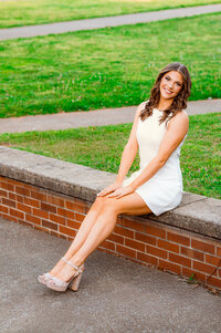 College senior dancer smiling at camera sitting on bench on the Middle Tennessee State University campus
