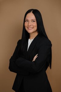Professional headshot of a woman business owner taken in a studio setting, projecting confidence and leadership