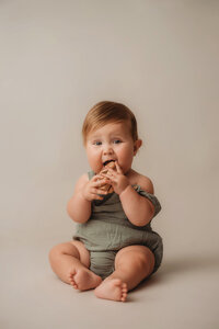 Baby teeths on a wooden toy during Baby Milestone Portrait Session at Holy City Babies Portrait Studio in Charleston, SC.