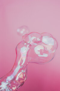 Voice over artist photographed through translucent pink material for expressive personal brand imagery.