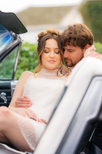 bride and groom embracing in classic car at hollins house in santa cruz
