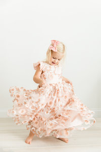 little girl twirling in pink dress