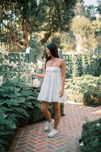 Palo Alto high school senior walking through Gamble Gardens during her senior photo session