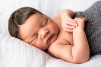 Close portrait of sleeping newborn baby in natural tones in Eastern North Carolina