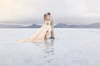 bride and groom kissing on salt flats