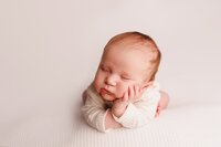Newborn baby sleeping in a soft neutral portrait during an omakase studio portrait session