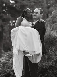 Black and white photo of a romantic moment with bride and groom at their wedding
