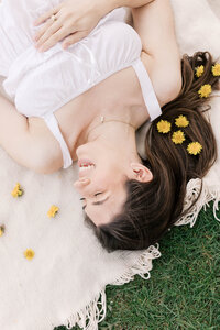woman with dandelions in her hair during peoria il maternity photos