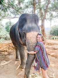 Monica Ann - travel photographer hugging an elephant