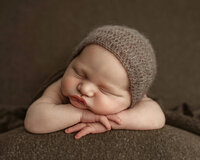 Sleepy newborn baby boy photographed during a studio newborn session in Denham Springs Louisiana
