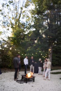 Guests mingle in backyard during Nantucket welcome party.